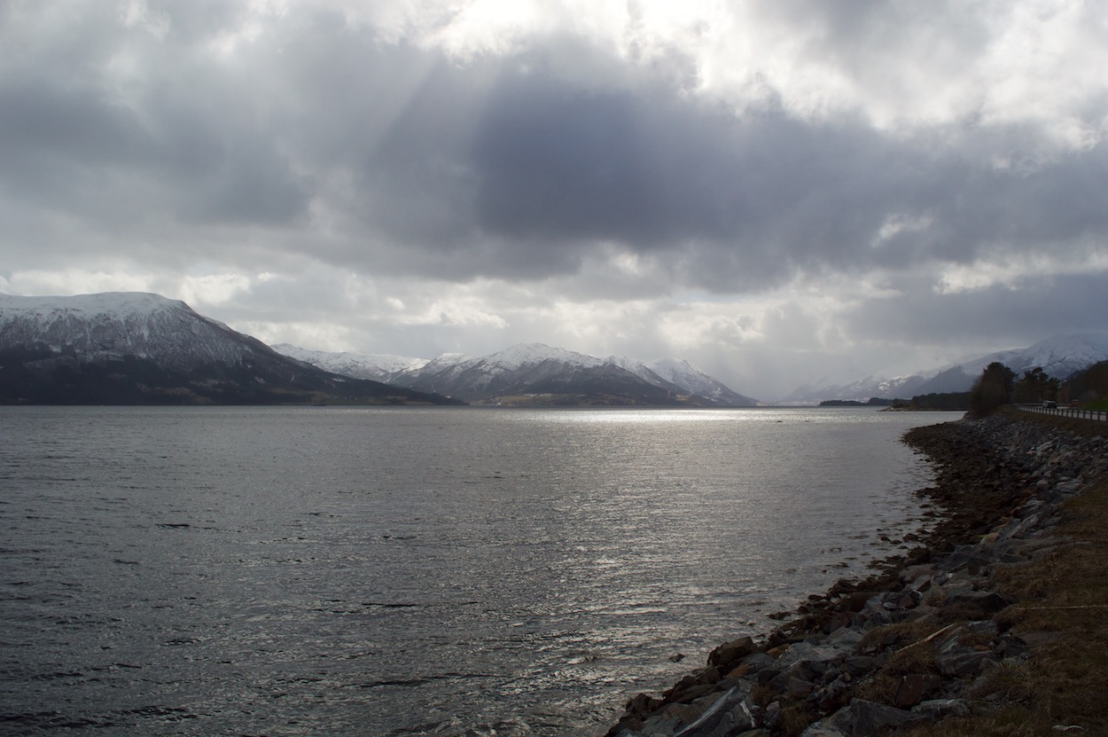 View of Sun Reflecting over the fjord and
                     mountains in More Og Romsdal, Norway