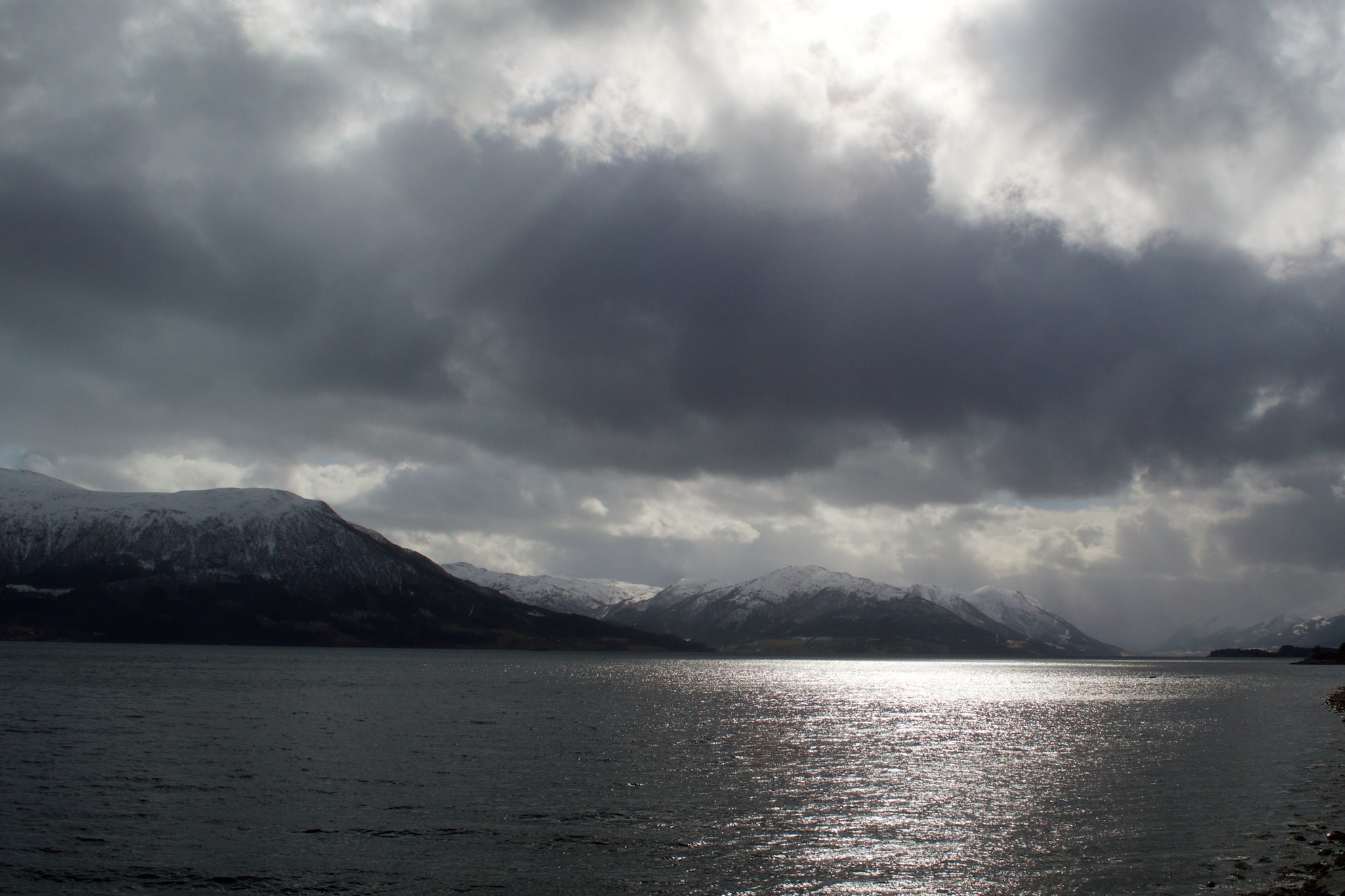 View of Sun Reflecting over the fjord and
                     mountains in More Og Romsdal, Norway