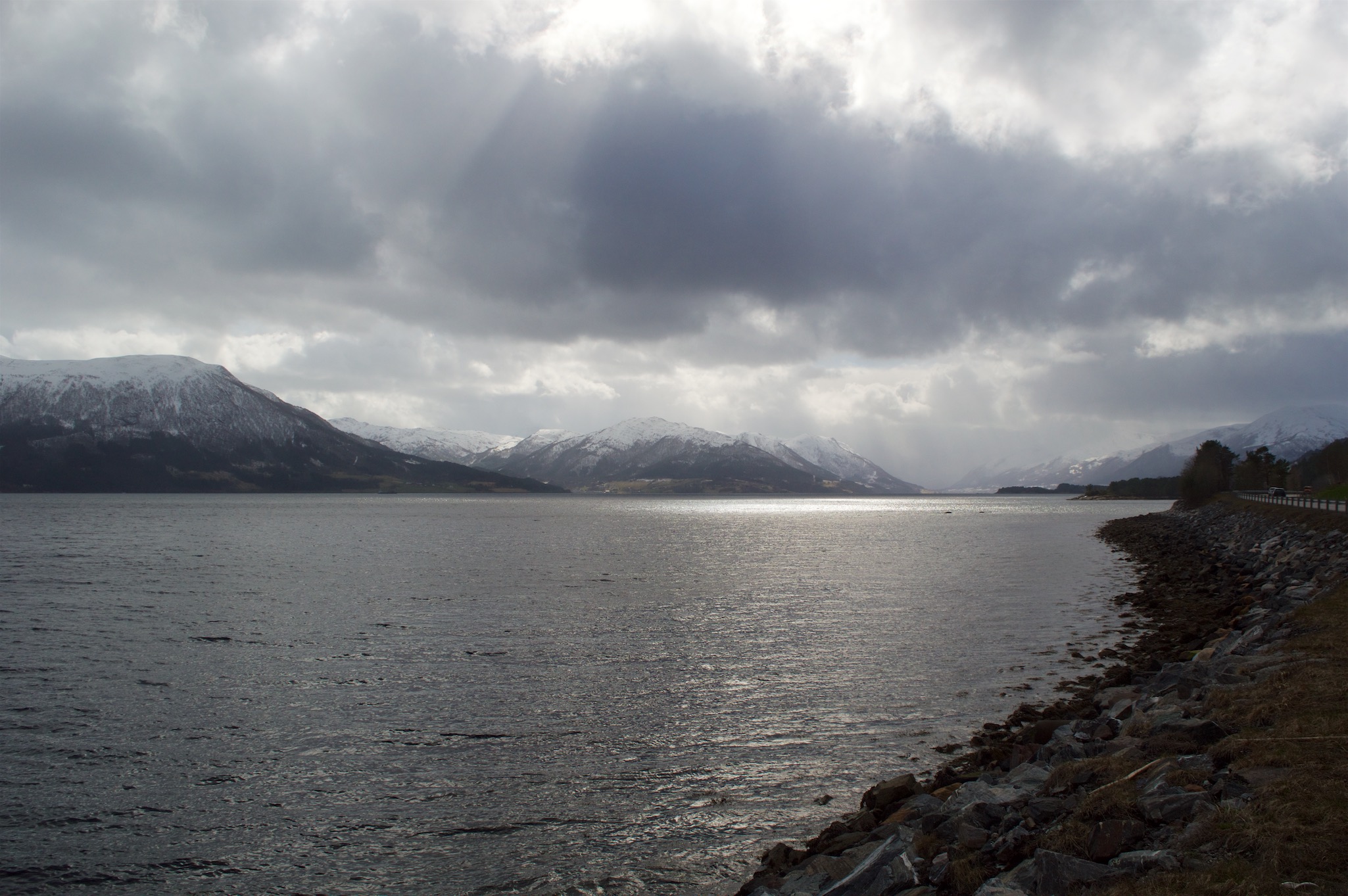 View of Sun Reflecting over the fjord and
                     mountains in More Og Romsdal, Norway