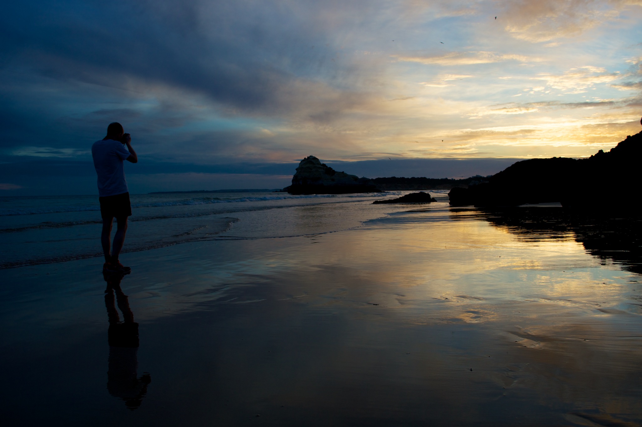 Photographer Taking Pictures on the Beach in Portimao Portugal at Sunset